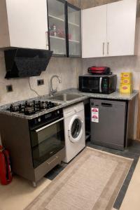 a kitchen with a stove and a washing machine at Royal Fsm Suites in Istanbul +80 photos