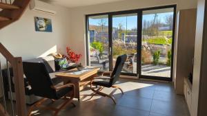 a living room with a desk and two chairs and a window at Domki i Apartamenty WiR na Kaszubach in Chmielno