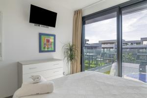 a bedroom with a bed and a large window at Atico de Lux Zahara in Zahara de los Atunes +25 photos