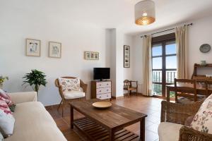 a living room with a couch and a table at Cobijadas75 Corredera in Vejer de la Frontera