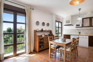 a kitchen with a table and a table and chairs at Cobijadas75 Corredera in Vejer de la Frontera