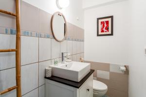 a bathroom with a white sink and a toilet at Gîte du Badassier in Blauvac +14 photos