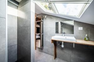 a bathroom with a sink and a skylight at Chalet Stéphane centre chatel in Châtel +27 photos