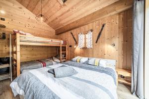 a bedroom with two beds in a log cabin at Chalet Stéphane centre chatel in Châtel