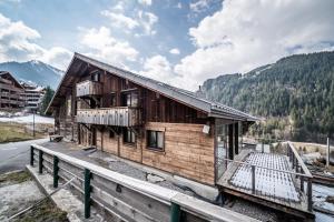 a wooden house on the side of a road at Chalet Stéphane centre chatel in Châtel