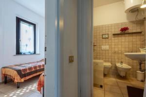 a bathroom with a sink and a toilet and a sink at Pergola 707 in Stintino