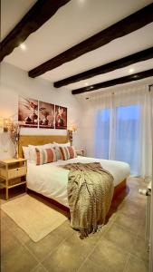 a bedroom with a large bed and a large window at Casa Rural El Olivo in Segovia +33 photos