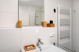 a bathroom with a sink and a mirror at Ferienwohnung Vogesenpanorama in Bad Bellingen +55 photos