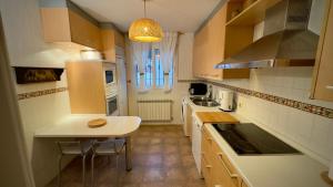 a kitchen with a sink and a table in it at Casa Rural El Olivo in Segovia