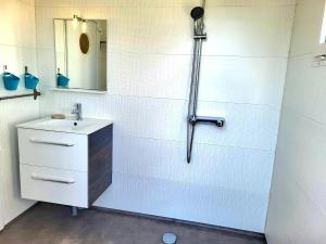 a bathroom with a sink and a shower at Maison De Plage La Payade in Pirou +11 photos