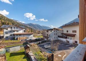 a view of a town with mountains in the background at Palazzo Righi - App Blu in Carisolo