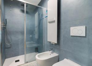 a bathroom with a toilet and a glass shower at Palazzo Righi - App Blu in Carisolo +14 photos