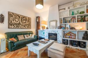 a living room with a green couch and a fireplace at Son Oliver in Palma de Mallorca
