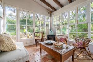 a living room with a table and chairs and windows at Son Oliver in Palma de Mallorca
