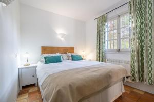 a bedroom with a large bed and a window at Son Oliver in Palma de Mallorca +17 photos