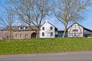 a large white house on a hill with trees at 't Wirkes in Schimmert