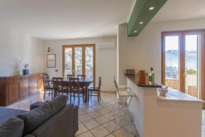 a living room with a couch and a kitchen with a table at Villa Lepre in Casarza Ligure
