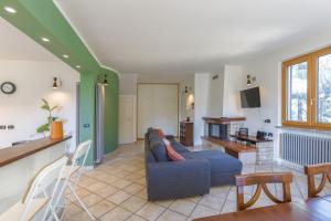 a living room with a blue couch and a table at Villa Lepre in Casarza Ligure
