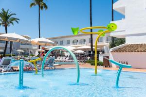 a pool with a water slide in a swimming pool at Apartamentos Solecito in Port d'Alcudia