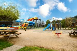 a park with a playground with a slide at Chalet Spa 2 Terrasse des Bouleaux in Ranspach