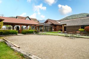 a house with a large patio in the yard at Chalet Spa 2 Terrasse des Bouleaux in Ranspach