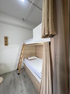 a bedroom with a bunk bed and a ladder at Therma Pilgrim Hostel in Caldas de Reis