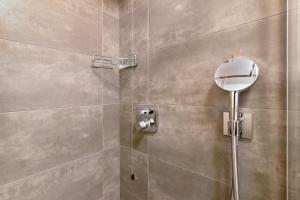 a shower with a glass door and a mirror at Appartamenti Via Dell'Asilo in Valdidentro +34 photos