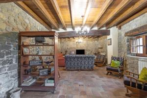 a living room with a stone wall at Mas Vinyoles in Centellas