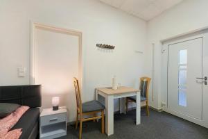 a room with a table and a bed and a table and chairs at Cozy 2-bed Room With Kitchen W2 in Beckingen