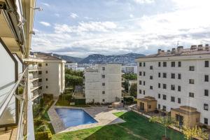 a view from the balcony of a building with a swimming pool at Roses Apartaments Luxury Duplex in Roses