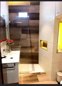 a bathroom with a sink and a shower with wood at Casa Miranda 3 in Igueste +13 photos