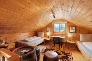 a room with a bed and a desk in a cabin at Wooden Western Lodge Tiny Haus in Brekendorf