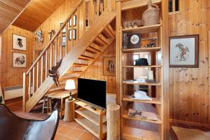 a living room with a staircase in a log cabin at Wooden Western Lodge Tiny Haus in Brekendorf +17 photos