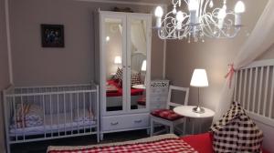 a baby room with a crib and a mirror at Märchengarten Hänsel und Gretel in Putbus