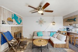 a living room with a couch and a table at Sandy Bottom VROBX in Kitty Hawk
