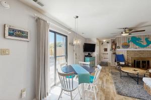a living room with a blue table and chairs at Sandy Bottom VROBX in Kitty Hawk