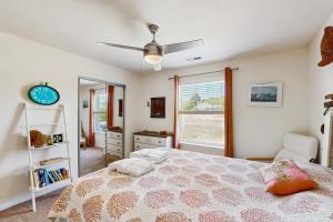 a bedroom with a bed and a clock and a mirror at Sandy Bottom VROBX in Kitty Hawk +19 photos
