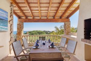 a table and chairs on a balcony with a view of the ocean at Roc Blau in Begur