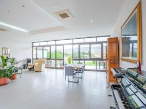 an empty lobby with a table and chairs and windows at Villa Germano con piscina in Solarino