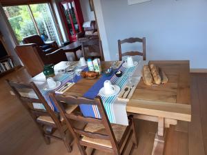 a dining room table and chairs with food on it at La Morinière in Vieux
