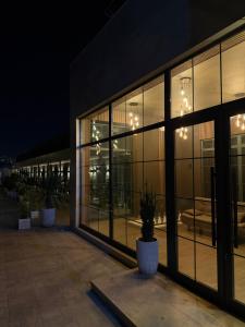 a large building with large glass windows at night at Yerevan Street hotel in Yerevan