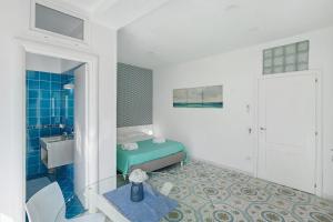 a white bathroom with a sink and a toilet at Le Suite del Castello in Castellammare di Stabia +69 photos
