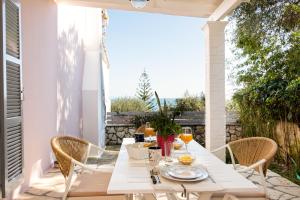 a white table and chairs on a patio at Kiki's Apartments in Barbati