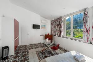 a living room with a table and a window at Le Suite del Castello in Castellammare di Stabia