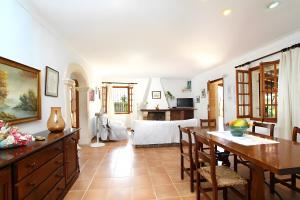 a kitchen and dining room with a table and chairs at Villa L´Embat in Pollença