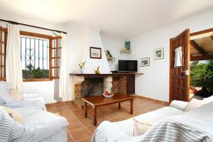 a living room with two couches and a fireplace at Villa L´Embat in Pollença