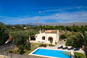 a villa with a swimming pool and a house at Villa L´Embat in Pollença