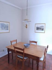 a dining room table with chairs and a bowl on it at De Kothuize 18 in Graaff-Reinet
