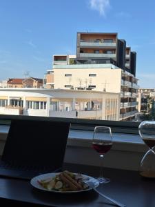 a table with a plate of food and a glass of wine at La nuit Douce in Annemasse