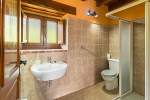 a bathroom with a sink and a toilet at Casa Alba in Bárcena de Cicero +18 photos
